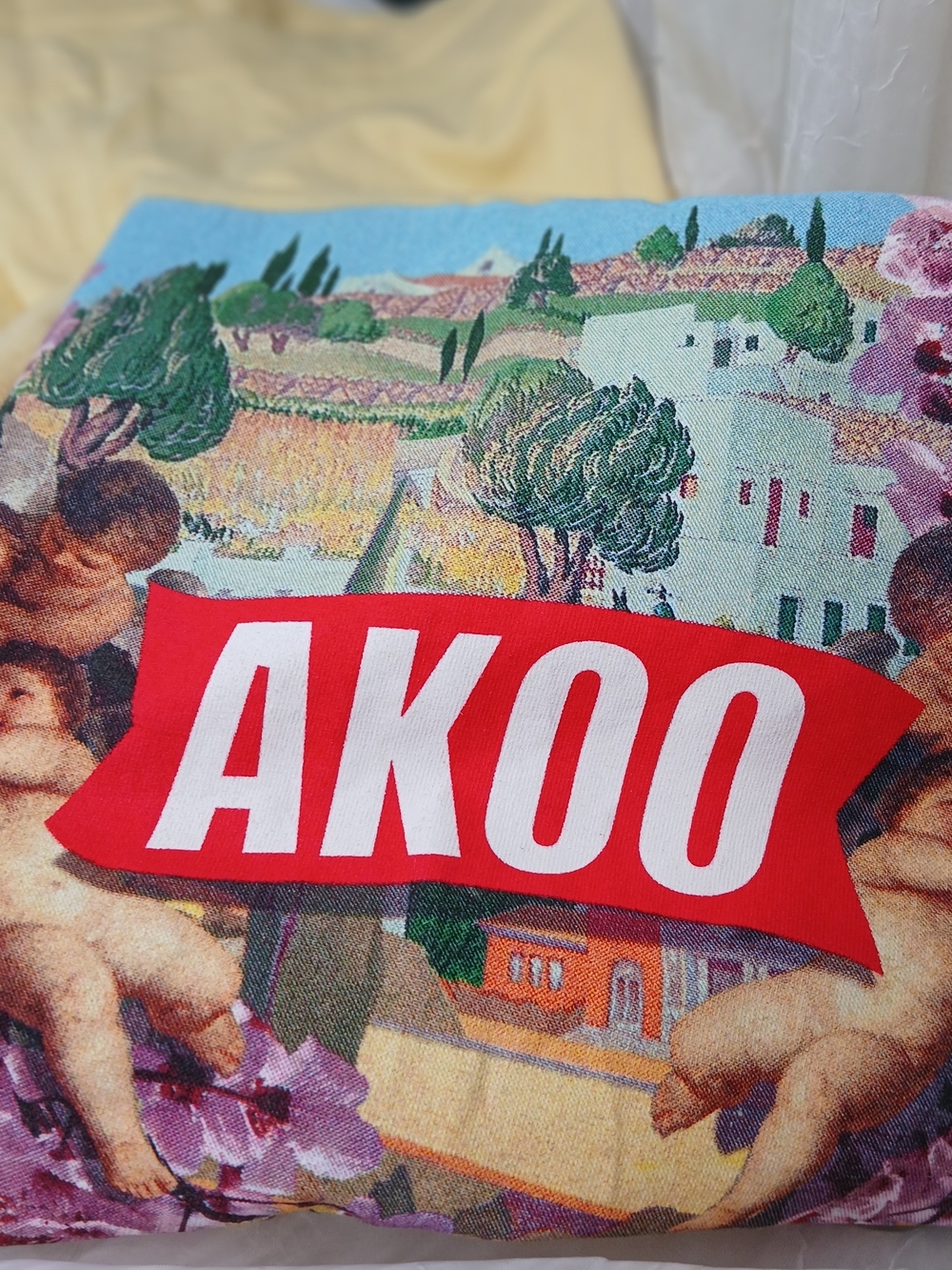 AKOO Graphic Logo Tee — Red and White on Multicolor Print